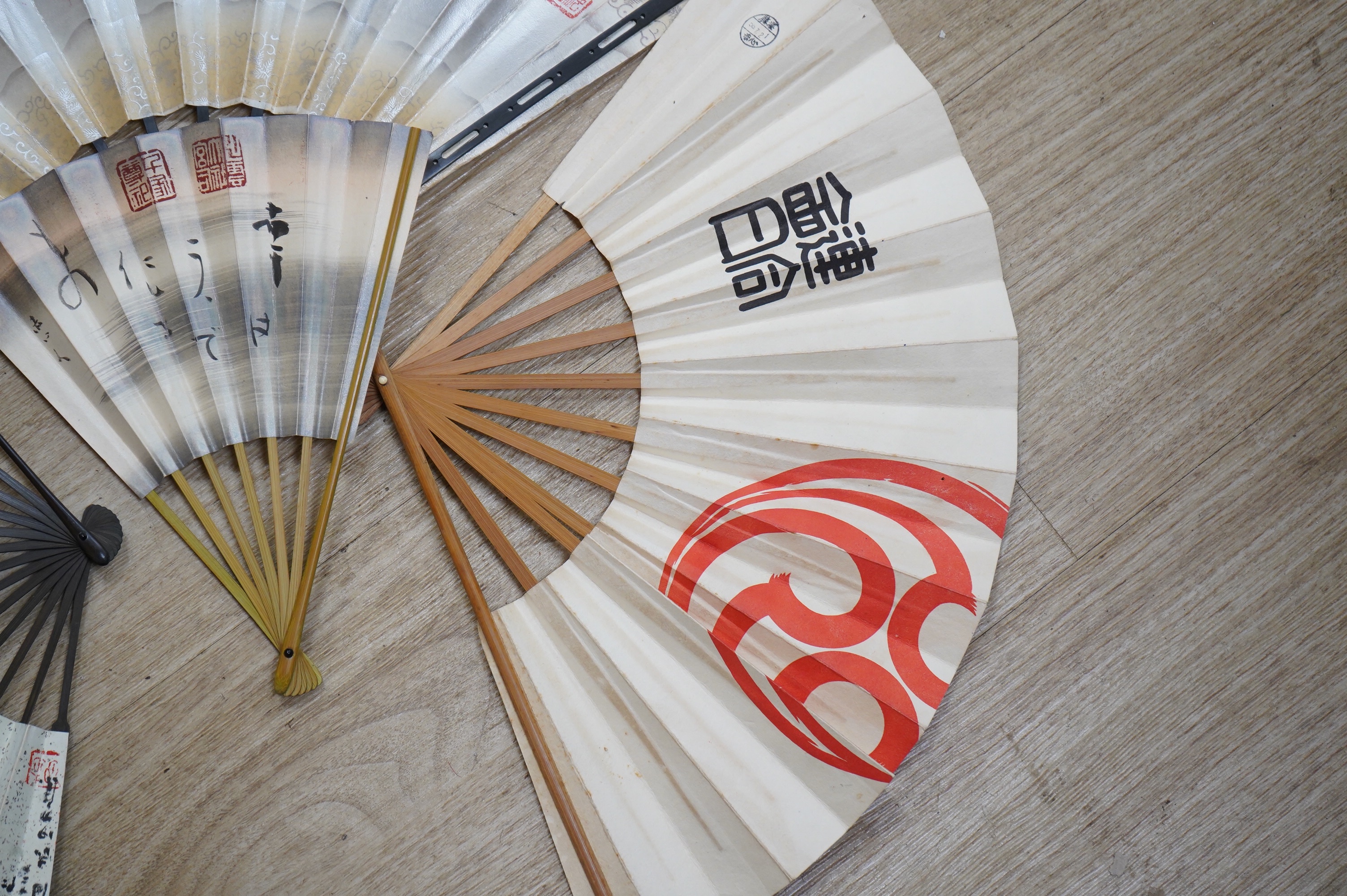 A collection of Japanese 20th century paper leaf fans, one hand painted with koi. Condition - varies, some rips/tears